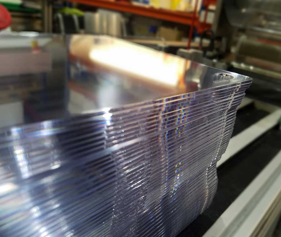A stack of laser cut acrylic number plate blanks